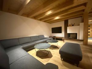 a living room with a couch and a table at Chalet Dahoam in Garmisch-Partenkirchen