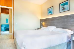 Säng eller sängar i ett rum på Hotel Vejo