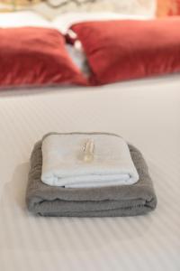 a white towel laying on top of a bed at Gabylou in Bordeaux