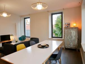 a living room with a white table and chairs at chez Nous in Vittel