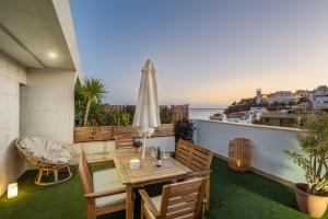 a balcony with a table and chairs and the ocean at Chada Morro Jable in Morro del Jable