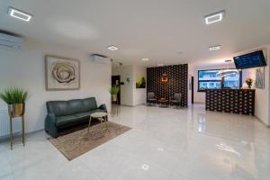 a lobby with a couch and a television in a building at 111Apartments in Košice +52 photos
