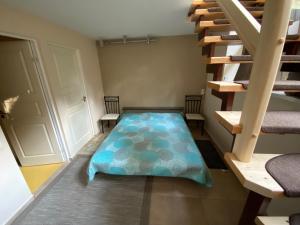 a room with a mattress on the floor next to a staircase at Kalnas II apartaments in Juodkrantė