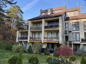 an exterior view of an apartment building with balconies at Kalnas II apartaments in Juodkrantė