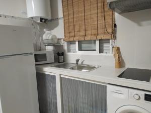a kitchen with a sink and a microwave at LA FUENTE 2 in El Gastor