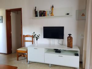 a white entertainment center with a television on top of it at Apartamento en Playa del Inglés Los Mangos in Playa del Ingles