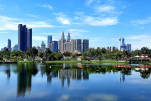 a city skyline with a large body of water at Titiwangsa Cabin Retreats by Vale Pine in Kuala Lumpur