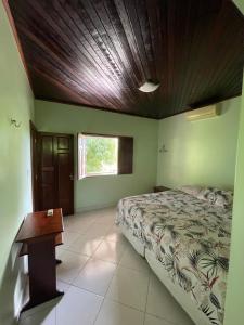 a bedroom with a bed and a wooden ceiling at Casa em Alter do chão - lago verde in Alter do Chao