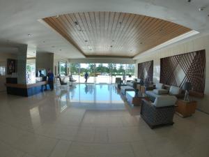 a lobby with couches and chairs in a building at Breezy Nest Staycation at Wind Residences Tagaytay in Tagaytay +50 photos