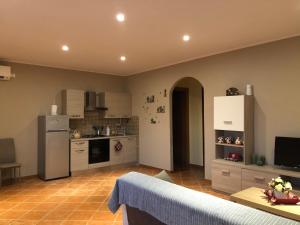 a kitchen with a refrigerator and a table in a room at La villetta senza tempo in Aprilia