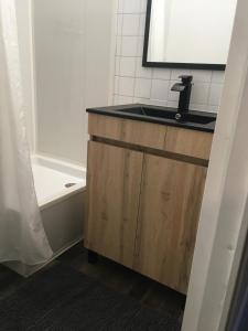 a bathroom with a sink and a bath tub at Studio 1 cabine chalet club III refait à neuf in Tignes