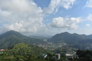 a view of a valley with mountains and a city at Baakhli Guest House and restaurant in Bhowāli