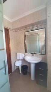 a bathroom with a sink and a mirror at Hostal Roberto in Palmanova
