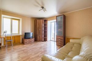 a living room with a couch and a television at Most City area 1-bedroom apartment, central in Dnipro +1 photo