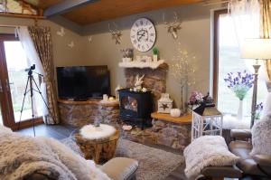 Un televizor și/sau centru de divertisment la West Horizon holiday cottage