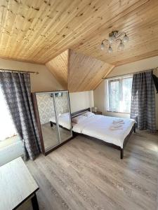 a bedroom with a large bed and a mirror at U Troh Brativ in Oryava