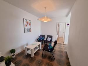 a living room with two chairs and a table at Holiday Home Prišćapac in Prizba