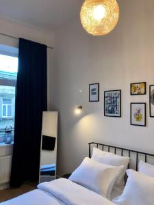 a bedroom with a bed and a chandelier at Park apartment in the heart of the city in Lviv