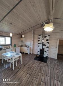 a room with a table and a stove in it at Travel inn Villas in Velikiy Novgorod