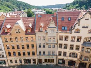 eine Gruppe von Gebäuden mit Bergen im Hintergrund in der Unterkunft Sächsischer Hof in Meißen