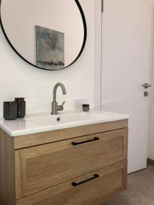 a bathroom with a sink and a mirror at Park apartment in the heart of the city in Lviv