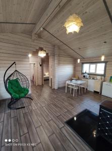 a room with a wooden floor with a swing at Travel inn Villas in Velikiy Novgorod