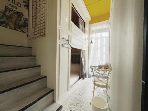 a hallway with a chair next to a window at Sennong Homestay in Tainan