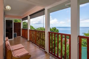 a balcony with a view of the ocean at Glacis Heights Villa in Glacis