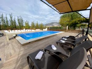 a swimming pool with lounge chairs and a swimming pool at Villa Elisabeth in Granada