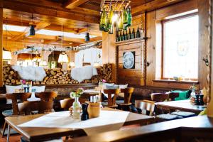a restaurant with wooden walls and tables and chairs at Hotel Reiter Bräu in Wartenberg