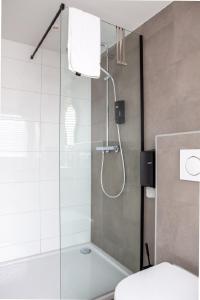 a bathroom with a shower with a glass door at Aan Dek Druten in Druten