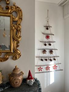 a christmas tree on a wall next to a mirror at Apartment Rue Centrale in Crans-Montana
