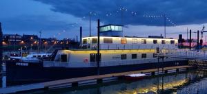 a large boat is docked at a dock at Aan Dek Druten in Druten +13 photos