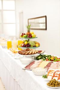 a long white table filled with lots of food at Austrian Pilgrim Hospice in Jerusalem