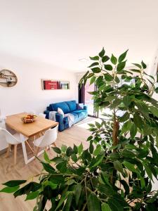 a living room with a blue couch and a table at Sea View in Playa del Aguila