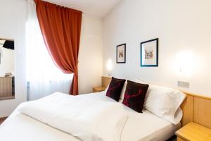 Postel nebo postele na pokoji v ubytování Albergo Dolomiti