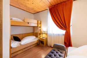 Postel nebo postele na pokoji v ubytování Albergo Dolomiti