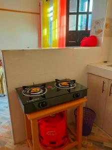 a kitchen with a stove with two plates on it at Amber Apartments G2 Kitengela in Athi River