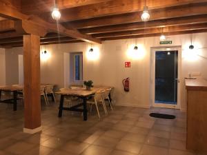 a dining room with tables and chairs and lights at LORENTX ATERPEA in Burguete