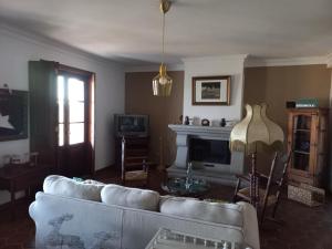 a living room with a couch and a fireplace at Aproveite o sabor do Alentejo in Vila Verde de Ficalho