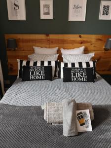 a bed with black and white pillows on it at SoQuiet in Lisbon