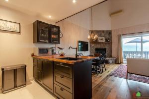 a kitchen with a sink and a counter top at Unique Tremblant view -fancy fully equipped apartment in Mont-Tremblant