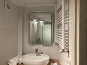 a white bathroom with a sink and a mirror at Sofie's Choice Mytilini Ι in Mytilene