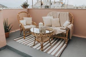 a couple of chairs and a table on a balcony at Bohemian Loft With View! in Volos
