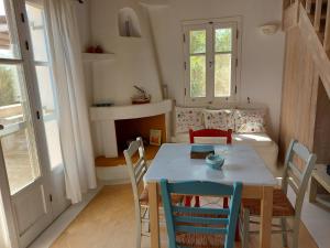 a dining room with a table and chairs at Simos suites in Elafonisos