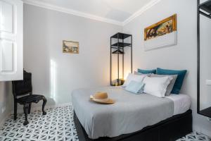 a bedroom with a bed with a hat on it at Heritage House Leiria in Leiria