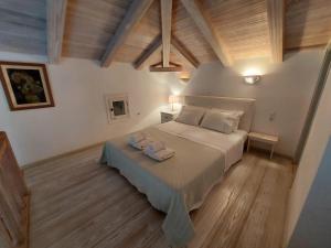 a bedroom with a bed with two towels on it at Simos suites in Elafonisos