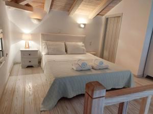 a bedroom with a bed with two towels on it at Simos suites in Elafonisos +34 photos