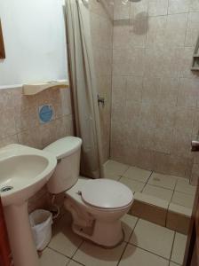 a bathroom with a toilet and a shower and a sink at My Best Stay Piedra del Mar in Puerto López