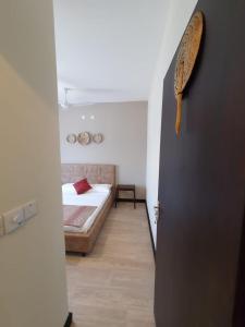 a door to a bedroom with a bed in a room at Elegant 1 Bedroom Condo Near Vipingo Ridge Golf Resort in Kilifi